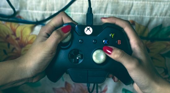 person-holding-microsoft-xbox-one-controller-1666759